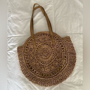 Tan woven round beach bag